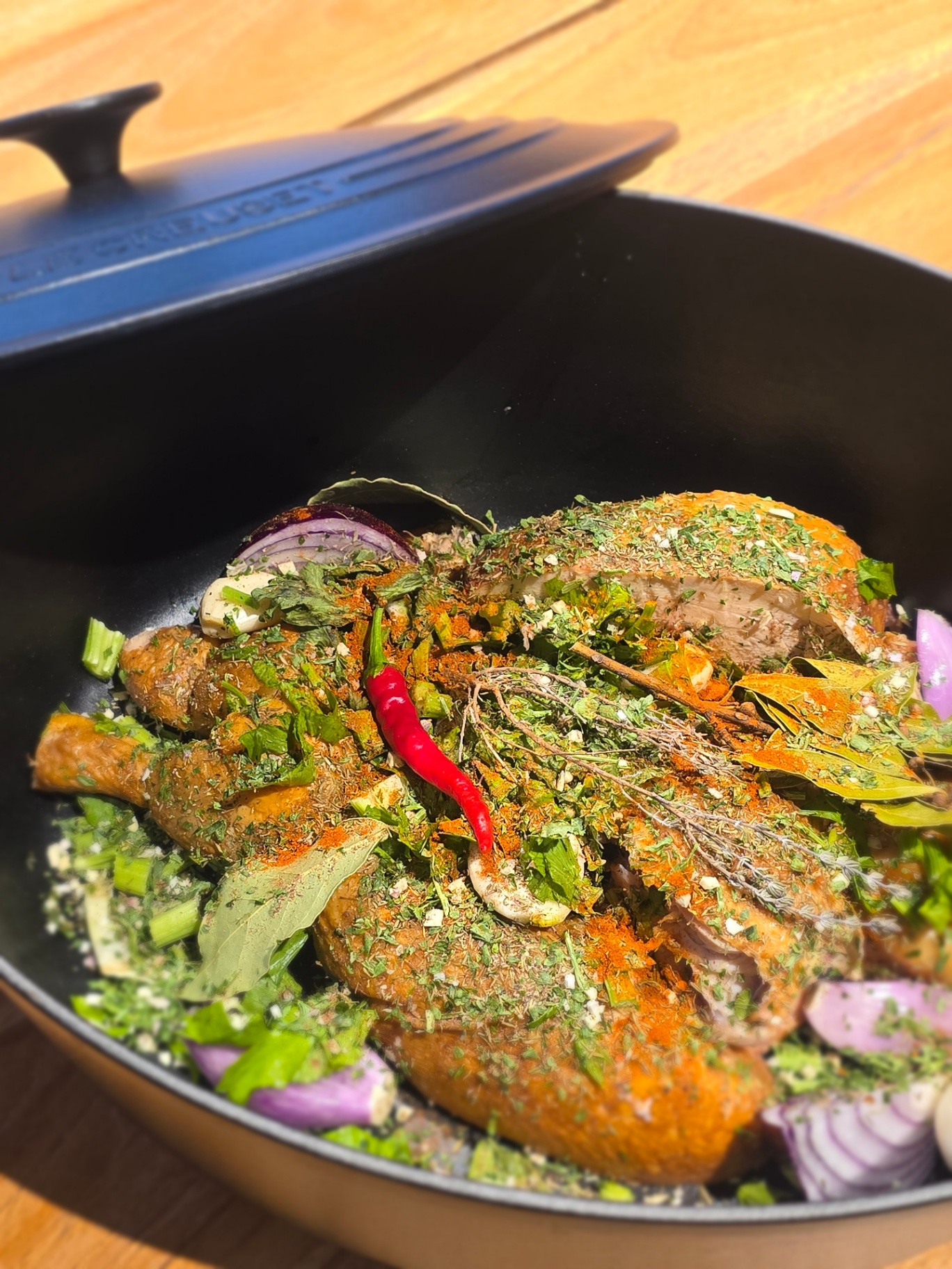 Poulet entier mariné aux épices et herbes fraîches en cocotte